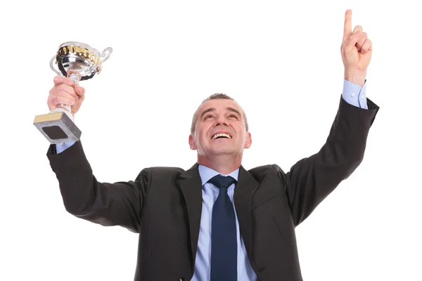 Business man cheers with trophy in hand — Stock Photo, Image