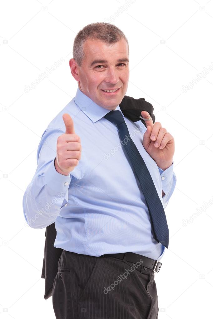 business man with jacket over shoulder shows thumb up