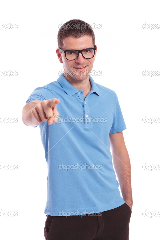 casual man points at you with hand in pocket