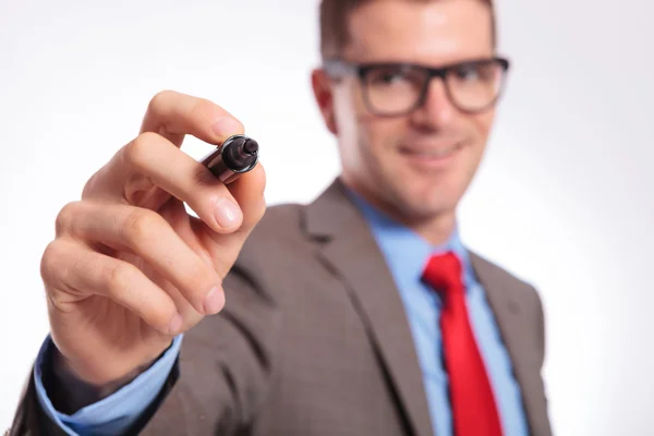 Young business man writes with marker on imaginary screen — Stock Photo, Image