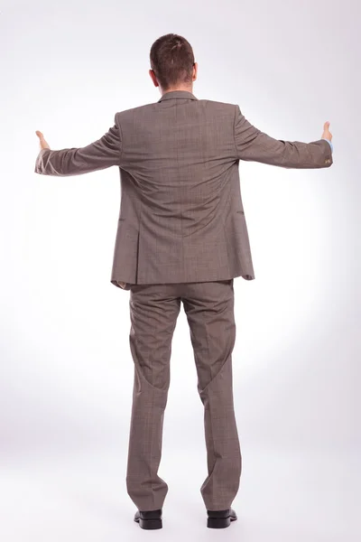 Back of a young business man with both thumbs up — Stock Photo, Image