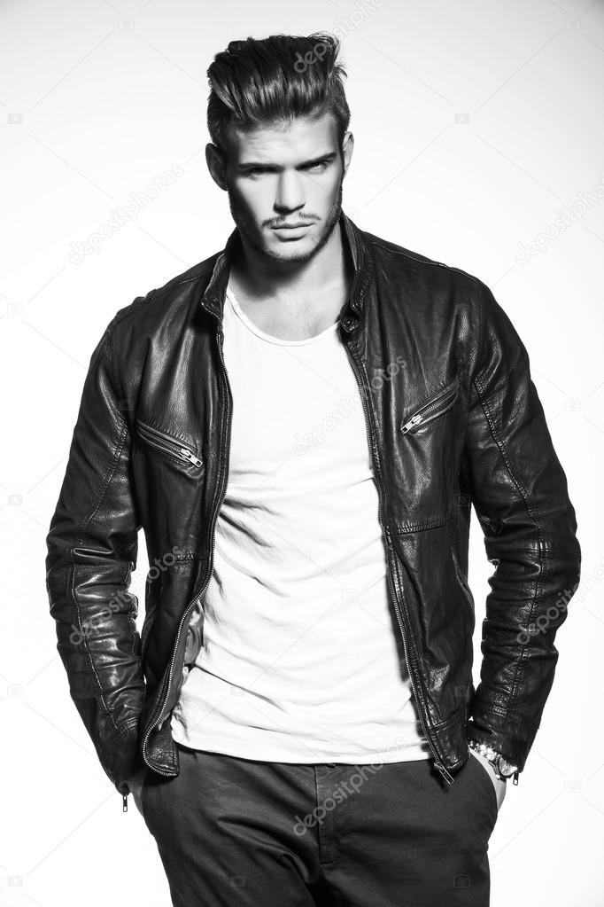 fashion model in leather jacket with hands in his pockets