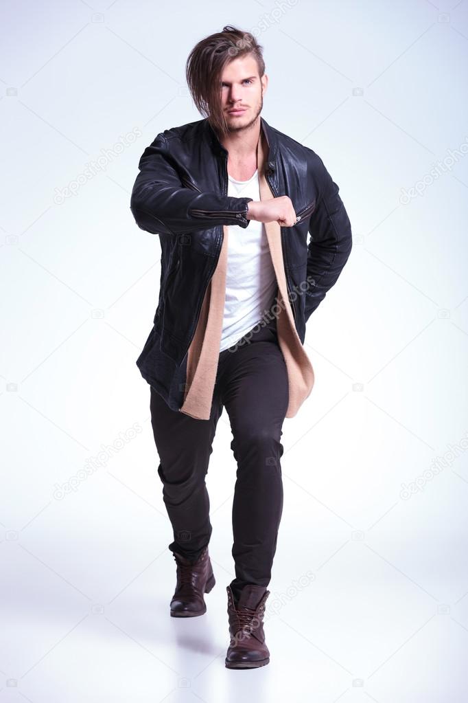 young man in leathe jacket in a fashion pose
