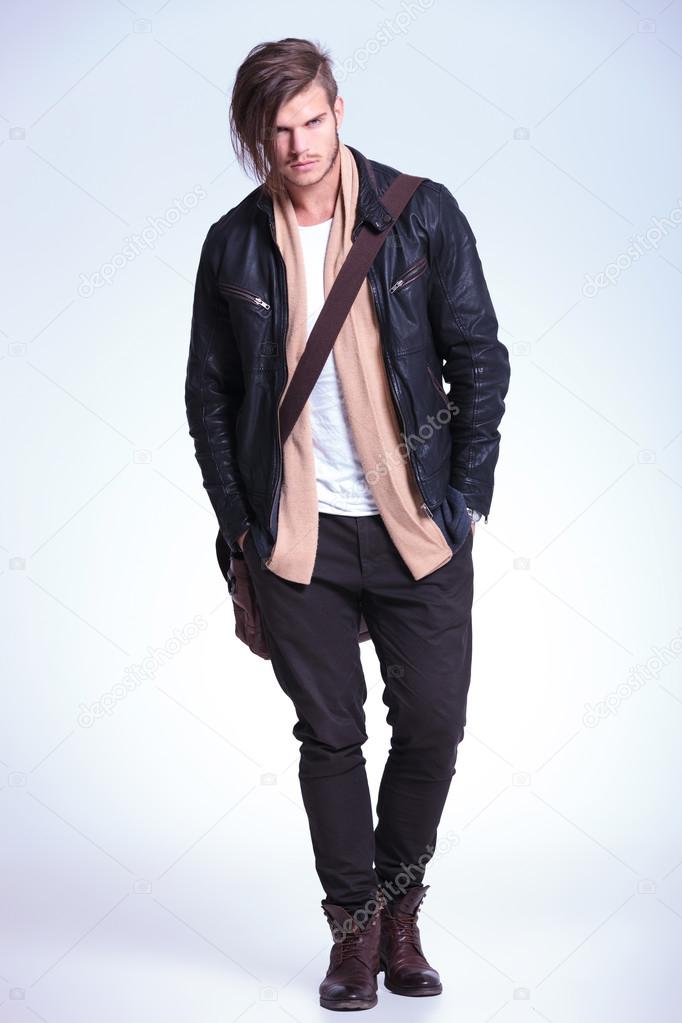 young fashion model in leather jacket and bag on shoulder