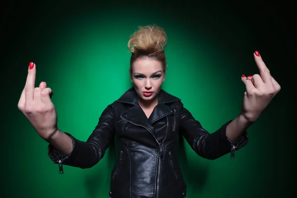 Young woman in leather jacket is flipping you off — Stock Photo, Image