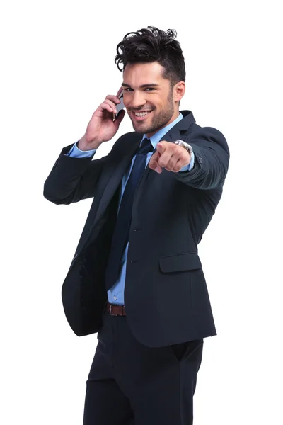 Business man pointing finger while talking on smartphone — Stock Photo, Image