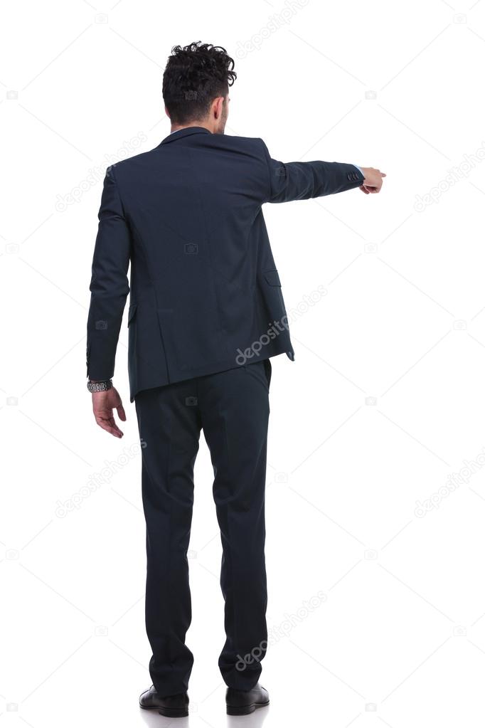 back of a young business man pointing his finger