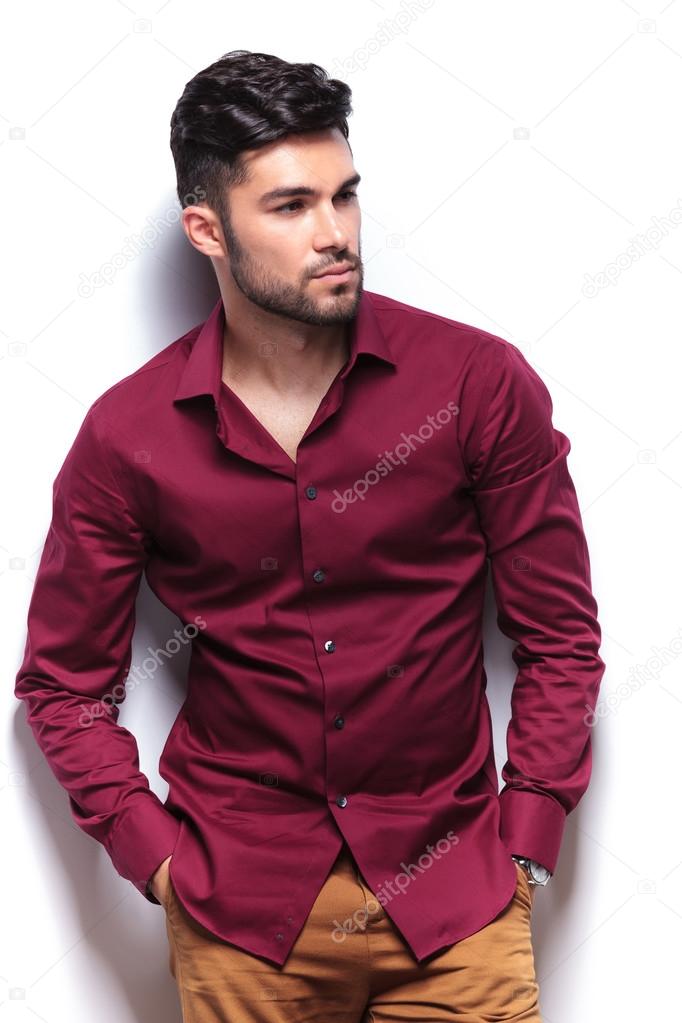 casual man looks away with hands in pockets