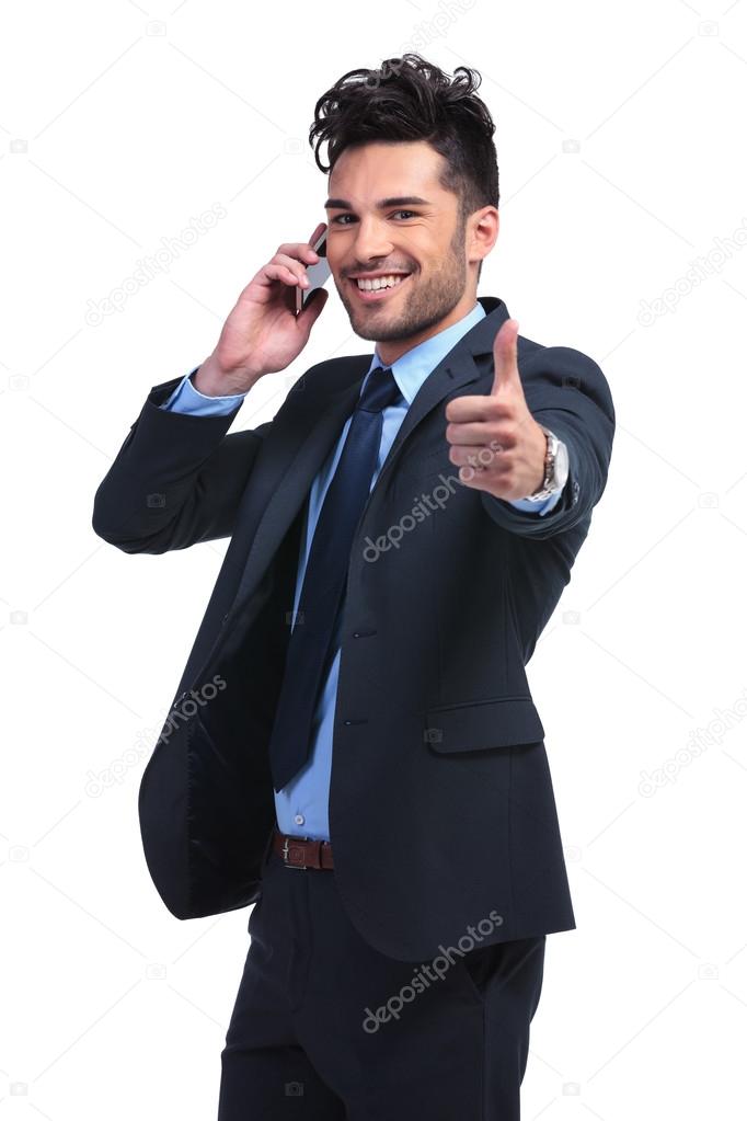 Young business man with very good news on the phone