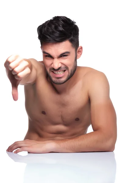 Naked man making the thumbs down sign — Stock Photo, Image