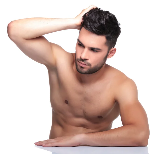 Man passing his hand through his hair and looking away — Stock Photo, Image