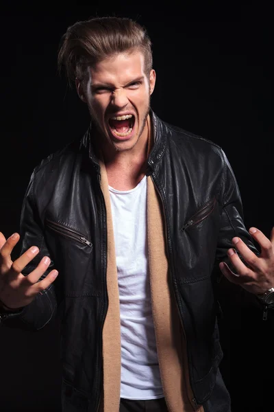 Angry young man screaming and gesturing — Stock Photo, Image