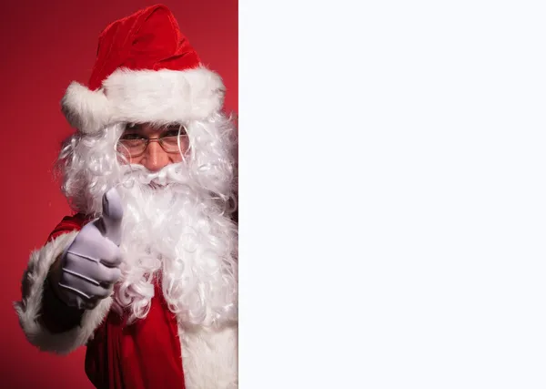 Père Noël Claude présente un tableau blanc et fait ok signe — Photo