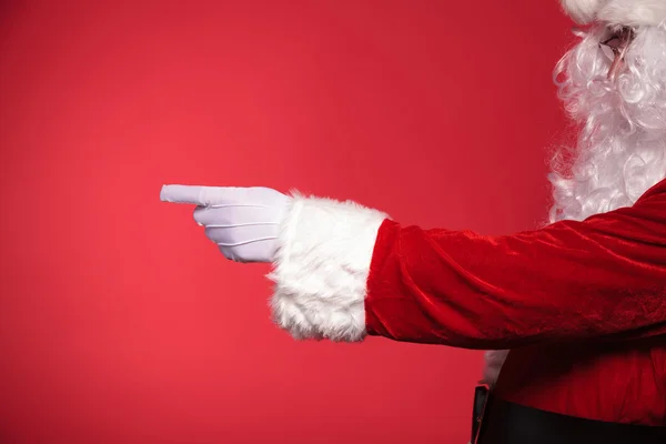 Visão lateral de Papai Noel apontando o dedo para algo — Fotografia de Stock