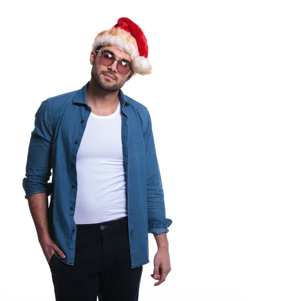 Relaxed young casual man wearing santa claus hat — Stock Photo, Image