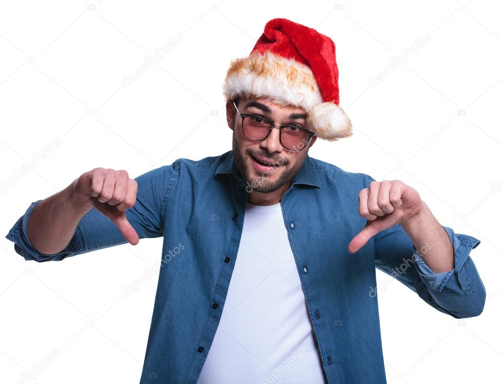 casual man in santa hat making the thumbs down