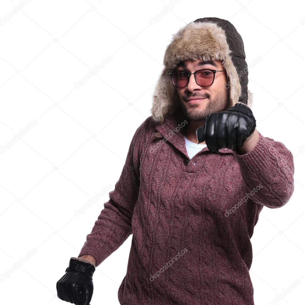 man in warms winter clothes is driving and imaginary car
