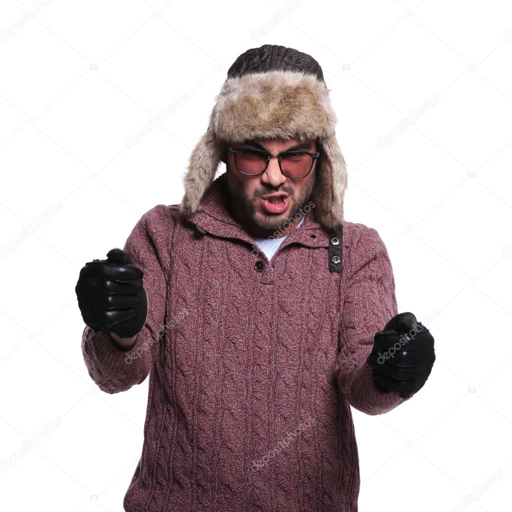 man in fur hat and leather gloves is driving an imaginary race c
