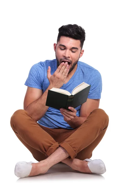 Student is reading a book and he gets sleepy — Stock Photo, Image