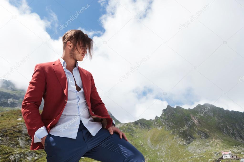 man looking away while standing in the mountains