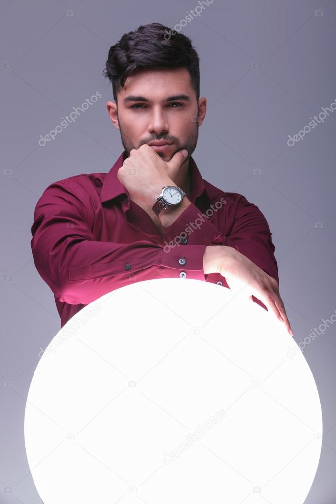 pensive young man and a ball of light