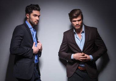 two male fashion models posing in studio
