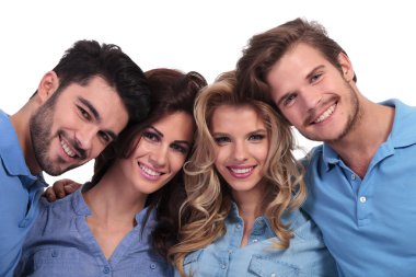 closeup picture of four casual young people smiling