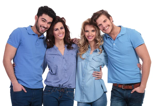 Embraced group of casual friends smiling — Stock Photo, Image