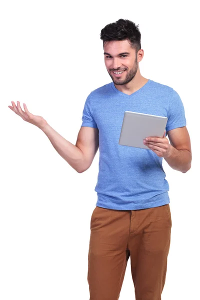 Casual man holding a tablet pad is inviting you — Stock Photo, Image