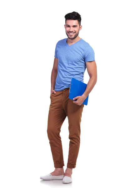 Full body picture of a young casual man holding notepad — Stock Photo, Image