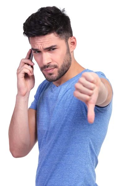 Young casual man with bad news on the phone — Stock Photo, Image