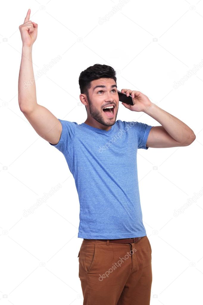 Excited man screaming while talking on the phone