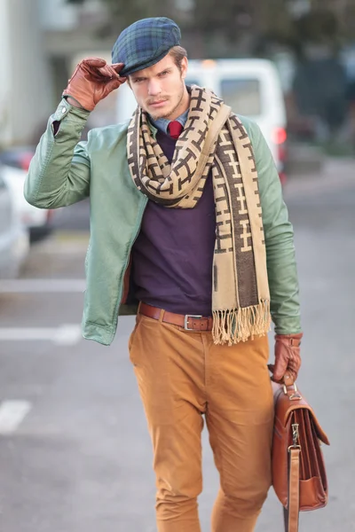 Fashion man holding his hat as a greeting — Stock Photo, Image