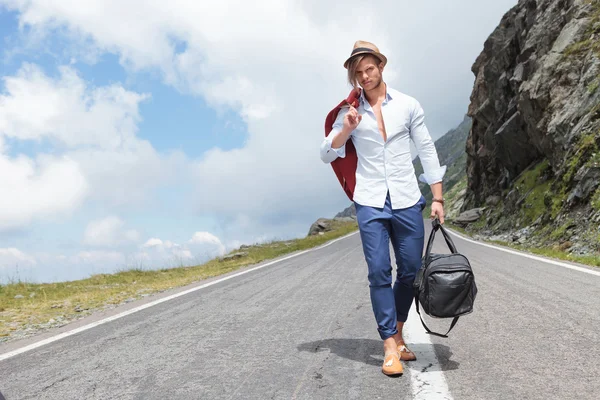 Young fashion man comes down the road — Stock Photo, Image