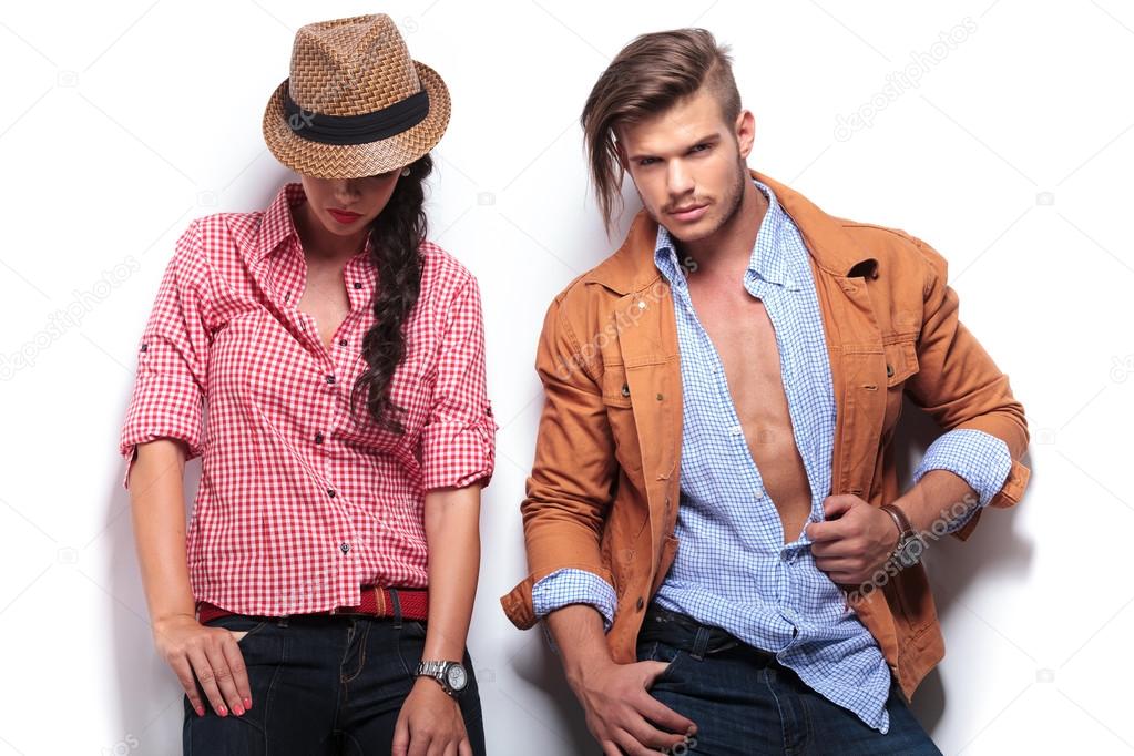 woman looking down while her boyfriend poses