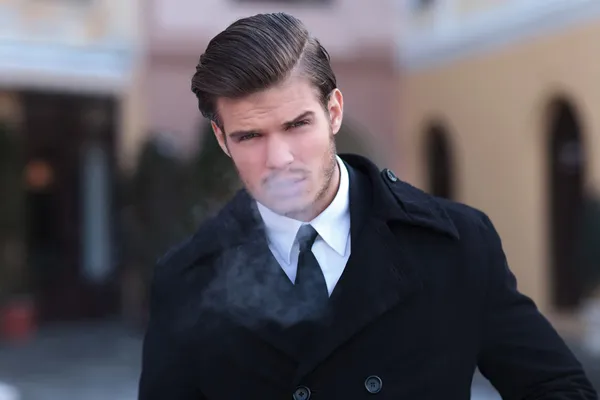 Portrait of young business man smoking — Stock Photo, Image