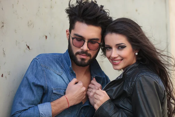 Young casual couple hold their jackets — Stock Photo, Image