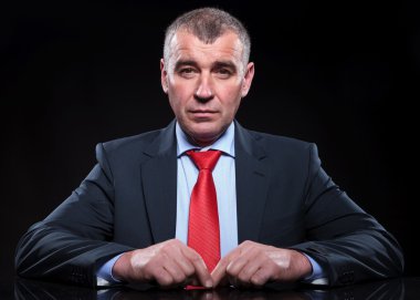 masasında oturan olgun iş adamı 