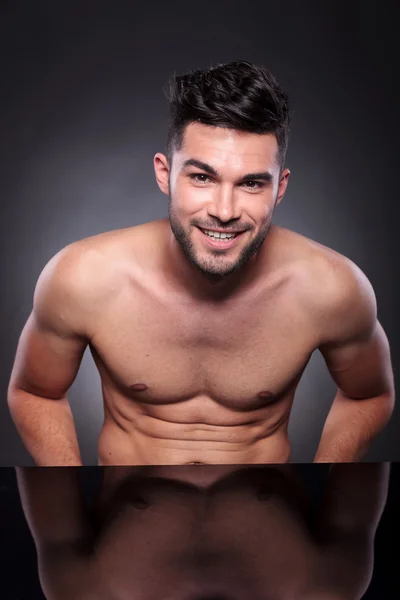 Young man with bare chest smiles at you — Stock Photo, Image