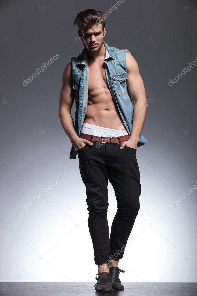 young shirtless man with hands in pockets