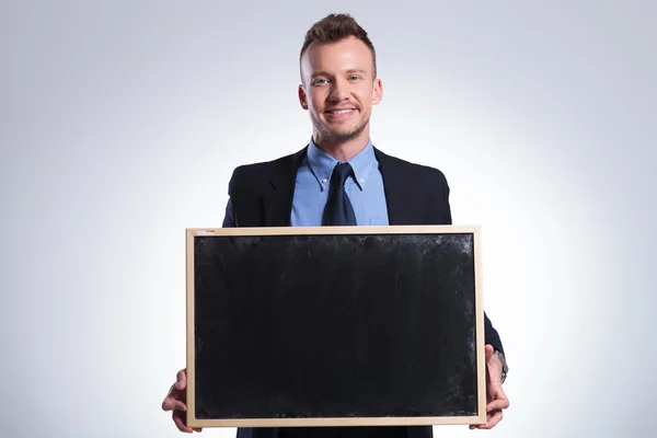 Business man holds a small chalkboard — Stock Photo, Image