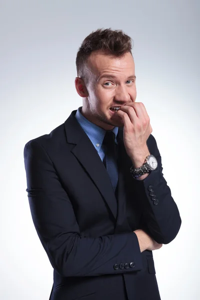 Business man bites his nails — Stock Photo, Image