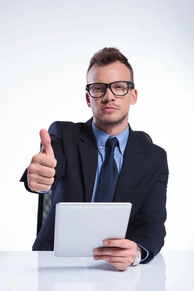 Business man with tablet shows ok Royalty Free Stock Photos