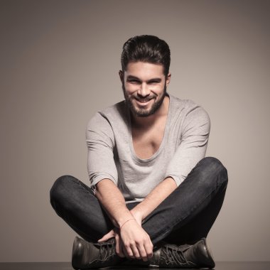 mutlu genç adam yoga konumda oturur 