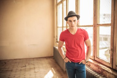 eski, kirli bir odada duran adam