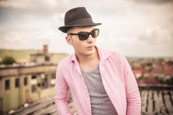 relaxed young man with hat and sunglasses