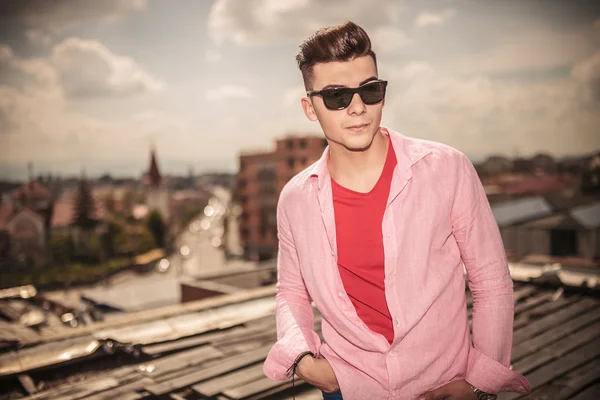 Man standing with hands in pockets on the roof top — Stock Photo, Image