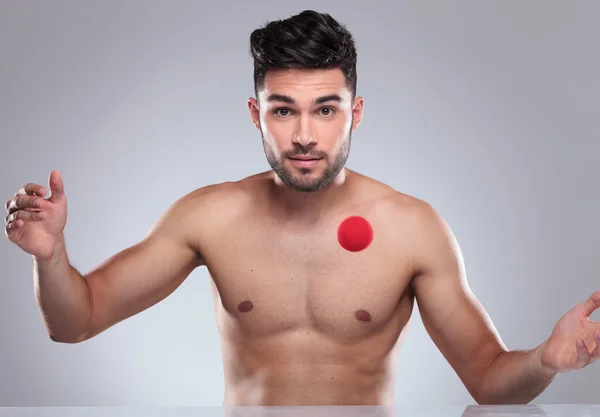 Sexy naked young man playing with a red ball — Stock Photo, Image