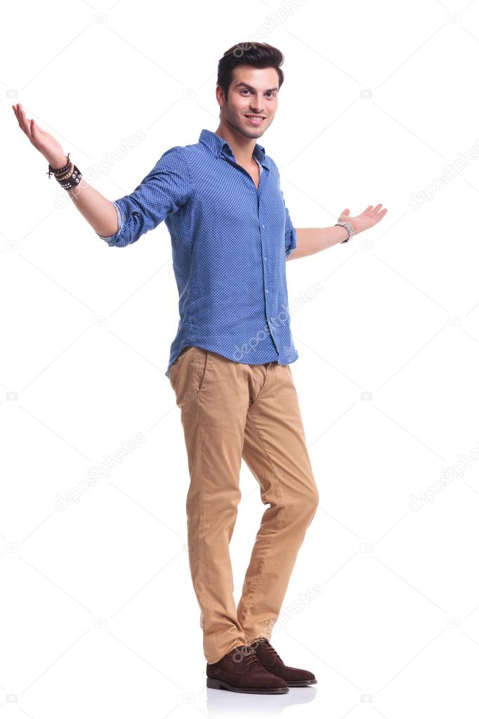 full body picture of a young casual man welcoming