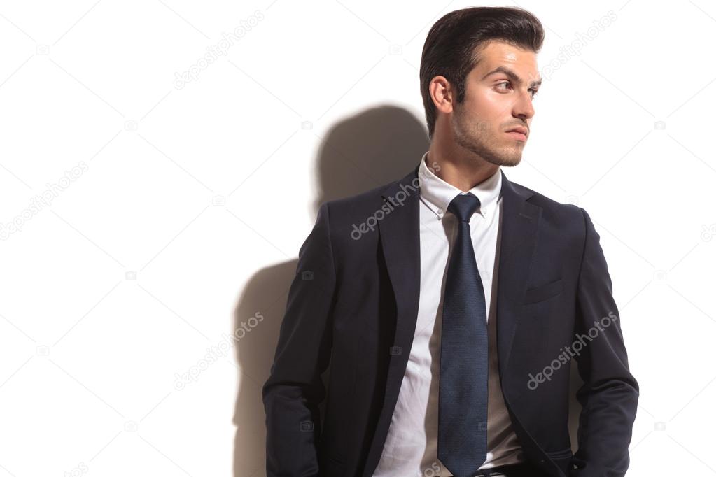 fashion business man looking over shoulder to his side